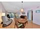 Open-concept living area with a dining space, comfortable furnishings, and a lovely view of the outdoors at 4260 Placida Rd # 25D, Englewood, FL 34224