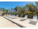 Community pool deck featuring lounge chairs and a beautiful outdoor area at 4260 Placida Rd # 25D, Englewood, FL 34224