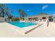 Community pool with clear blue water and lounge seating at 4260 Placida Rd # 25D, Englewood, FL 34224
