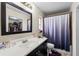 Bathroom with shower-tub combo, large vanity mirror, and a view into the walk-in closet at 427 Canterbury Rd, Venice, FL 34293