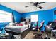 Bedroom with a ceiling fan, bed, desk, and chair, offering a personal space for relaxation and productivity at 427 Canterbury Rd, Venice, FL 34293