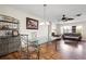 Dining area with glass-top table and modern chandelier lighting, flowing seamlessly into the living area at 427 Canterbury Rd, Venice, FL 34293