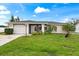 Charming single-story home with a well-maintained lawn, lush landscaping, and a convenient attached garage at 427 Canterbury Rd, Venice, FL 34293