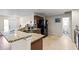 Bright kitchen with granite counters, breakfast bar, modern appliances, and convenient access to a half bathroom at 427 Canterbury Rd, Venice, FL 34293