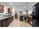 Modern kitchen with stainless steel appliances, granite countertops, and ample cabinet space, open to the dining area at 427 Canterbury Rd, Venice, FL 34293
