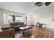 Inviting living room with wood floors, neutral walls, and a large window offering plenty of natural light at 427 Canterbury Rd, Venice, FL 34293