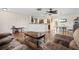 Spacious living area featuring wood floors, comfortable seating, and an open layout leading to the kitchen and dining area at 427 Canterbury Rd, Venice, FL 34293