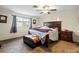 Comfortable bedroom with a large window, ceiling fan, and neutral carpeting, creating a cozy retreat at 427 Canterbury Rd, Venice, FL 34293