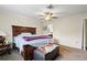 Cozy bedroom with ceiling fan, carpet flooring, and ensuite bathroom access at 427 Canterbury Rd, Venice, FL 34293