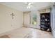 Bright sun room with tiled floor and bookshelf, leading to the backyard at 427 Canterbury Rd, Venice, FL 34293