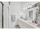 Bright bathroom features a double sink vanity, linen cabinets and shower-tub combination at 4433 Corso Venetia Blvd # C18, Venice, FL 34293