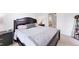 Comfortable bedroom with dark wood furniture, a closet, and a view of the bathroom at 4433 Corso Venetia Blvd # C18, Venice, FL 34293