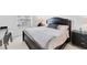 Bedroom with dark wood furniture, large window, and dedicated desk space at 4433 Corso Venetia Blvd # C18, Venice, FL 34293