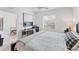 Well-lit bedroom featuring a desk, window, and view of the adjacent dining area at 4433 Corso Venetia Blvd # C18, Venice, FL 34293