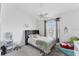 Bright bedroom with a large window and ceiling fan at 4433 Corso Venetia Blvd # C18, Venice, FL 34293
