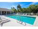 Outdoor pool in a community, featuring clear water, lounge chairs, and a covered seating area at 4433 Corso Venetia Blvd # C18, Venice, FL 34293