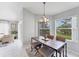 Open dining area with views of trees, adjacent to sliding doors and sitting area at 4433 Corso Venetia Blvd # C18, Venice, FL 34293