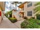 Inviting exterior view of a condo building with well-maintained landscaping and exterior staircase at 4433 Corso Venetia Blvd # C18, Venice, FL 34293