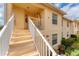 Exterior view of a condo building featuring outdoor stairs and well-manicured landscaping at 4433 Corso Venetia Blvd # C18, Venice, FL 34293