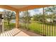 Screened lanai with a view of a grassy lawn and a pond at 4433 Corso Venetia Blvd # C18, Venice, FL 34293