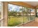 Screened lanai with a view of lush greenery and building exteriors at 4433 Corso Venetia Blvd # C18, Venice, FL 34293