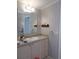 Bathroom vanity with mirror and decorative striped wallpaper at 457 Longwood Dr, Venice, FL 34285