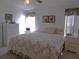 Bedroom with an ample amount of daylight, floral decorations, and a dresser at 457 Longwood Dr, Venice, FL 34285
