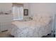 Bright bedroom with a floral designed bedspread and a dresser at 457 Longwood Dr, Venice, FL 34285