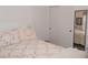 Bright bedroom with a floral designed bedspread and mirror at 457 Longwood Dr, Venice, FL 34285