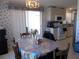 Charming dining area next to kitchen with sliding doors to patio and traditional wallpaper at 457 Longwood Dr, Venice, FL 34285