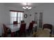 Formal dining room with chandelier and French doors offering a perfect space to entertain at 457 Longwood Dr, Venice, FL 34285
