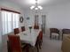 Formal dining room with chandelier and French doors offering a perfect space to entertain at 457 Longwood Dr, Venice, FL 34285
