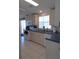 Clean kitchen with appliances, tiled flooring and access to outdoor patio with sliding glass door at 457 Longwood Dr, Venice, FL 34285