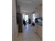 Well-lit kitchen featuring appliances, white cabinetry, and a dining area with a chandelier at 457 Longwood Dr, Venice, FL 34285