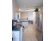 Bright kitchen with white cabinets, essential appliances, and tiled flooring for easy maintenance at 457 Longwood Dr, Venice, FL 34285