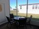 Enclosed outdoor patio with a seating area, offering a cozy spot to enjoy the fresh air and views at 457 Longwood Dr, Venice, FL 34285