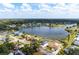 Aerial view of home in lakeside community with lush green trees and bright blue sky at 4740 Payne St, North Port, FL 34287