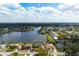 Aerial view of home in lakeside community with lush green trees and bright blue sky at 4740 Payne St, North Port, FL 34287