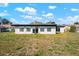 The backyard is spacious with green grass and a view of the rear of the home at 4740 Payne St, North Port, FL 34287