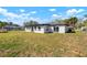 Spacious backyard with healthy lawn and great sun exposure and rear exterior of house at 4740 Payne St, North Port, FL 34287
