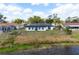Tranquil waterfront backyard with a privacy fence, perfect for outdoor enjoyment at 4740 Payne St, North Port, FL 34287