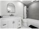 Modern bathroom with updated vanity, countertop, mirror, shower, and gray wall tiles at 4740 Payne St, North Port, FL 34287