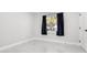 Bedroom featuring sleek tiled flooring, modern trim, neutral paint, and a window for natural light at 4740 Payne St, North Port, FL 34287