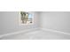 A sunlit bedroom featuring neutral walls, modern tiled floors, and a window at 4740 Payne St, North Port, FL 34287