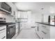 Bright kitchen featuring white cabinetry, stainless steel appliances and new countertop at 4740 Payne St, North Port, FL 34287