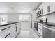 Modern kitchen with sleek cabinets, stainless appliances, and marble floors at 4740 Payne St, North Port, FL 34287