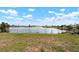 Panoramic lake view with fence and grass separating the backyard from the water at 4740 Payne St, North Port, FL 34287