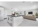 Open living space featuring an island with barstool seating and seamlessly integrated living area at 4740 Payne St, North Port, FL 34287