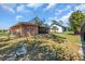 Lush backyard with privacy fence, green grass, and a covered patio perfect for outdoor living at 491 Conrad Rd, Venice, FL 34293