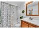 Clean bathroom features a shower and tub combo, and a wood trimmed mirror at 491 Conrad Rd, Venice, FL 34293